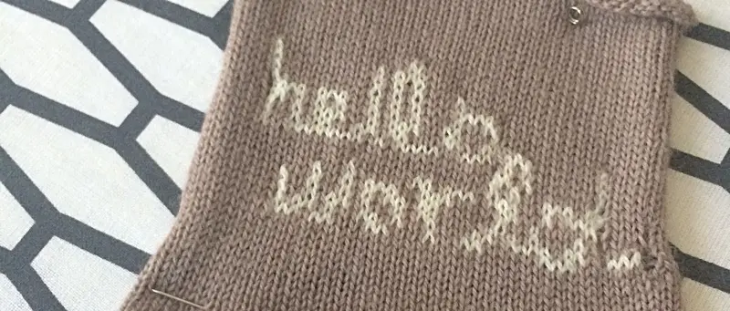 'Hello World' knit in white into brown fabric